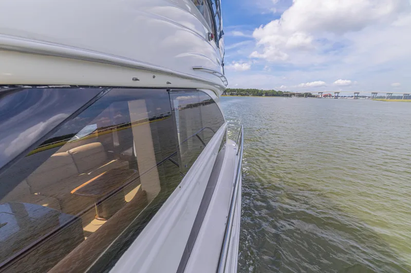  Yacht Photos Pics 2006 Meridian 341 Sedan cruising on a sunny day, reflecting water and sky.