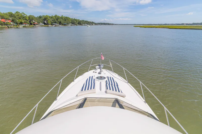  Yacht Photos Pics Bow view of 2006 Meridian 341 Sedan yacht cruising on a serene river.