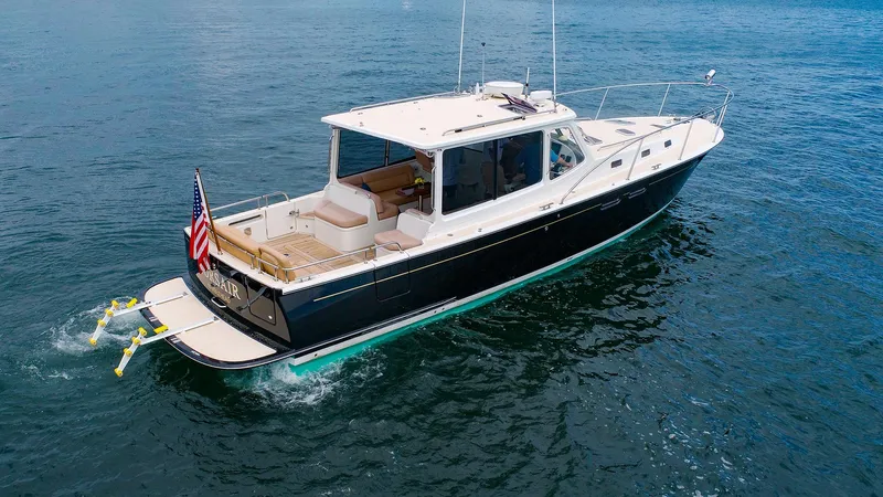 4750fr Yacht Photos Pics 2012 MJM 40z Downeast yacht cruising on open water, rear view.