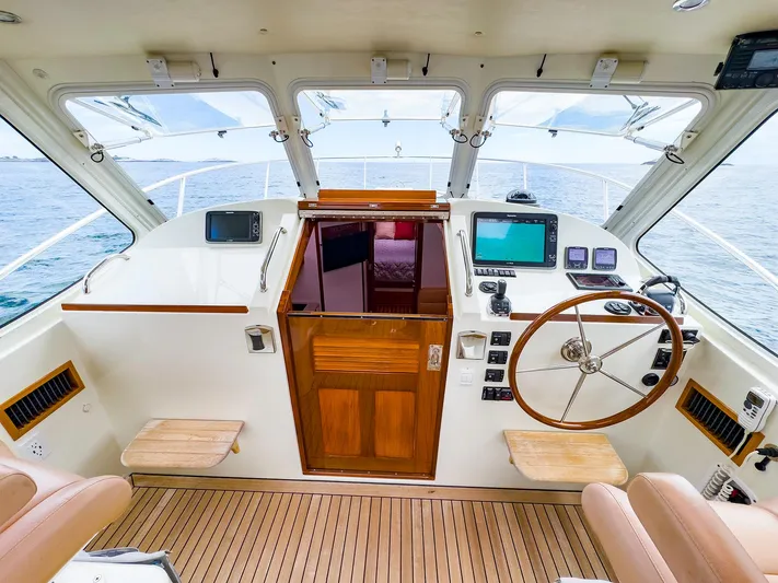 4750fr Yacht Photos Pics 2012 MJM 40z Downeast boat helm with wooden accents and modern navigation equipment.