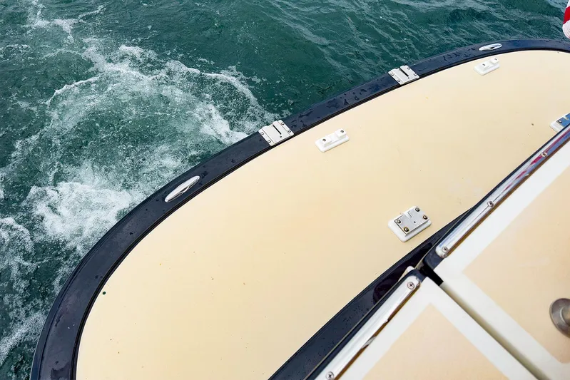 4750fr Yacht Photos Pics 2012 MJM 40z Downeast boat stern on water, showcasing deck and wake.