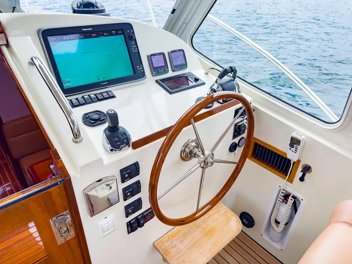 4750fr Yacht Photos Pics Helm of 2012 MJM 40z Downeast boat with navigation equipment and wooden steering wheel.
