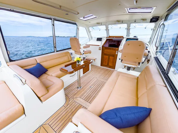 4750fr Yacht Photos Pics 2012 MJM 40z Downeast yacht interior with beige seating and ocean view.