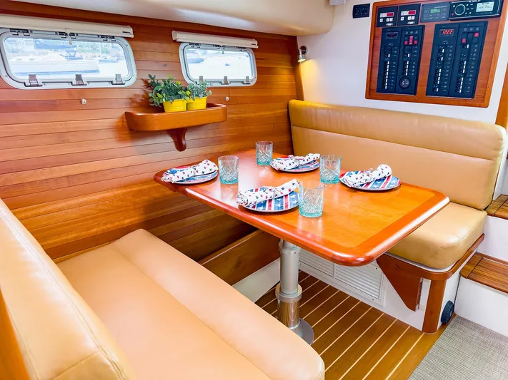 4750fr Yacht Photos Pics Interior of 2012 MJM 40z Downeast yacht with dining area and wooden accents.