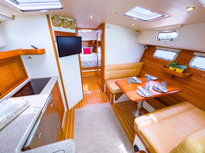 4750fr Yacht Photos Pics Luxurious interior of 2012 MJM 40z Downeast yacht with dining area and kitchenette.