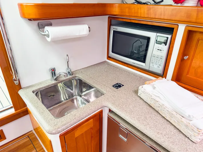 4750fr Yacht Photos Pics Compact kitchen area in a 2012 MJM 40z Downeast boat with sink and microwave.
