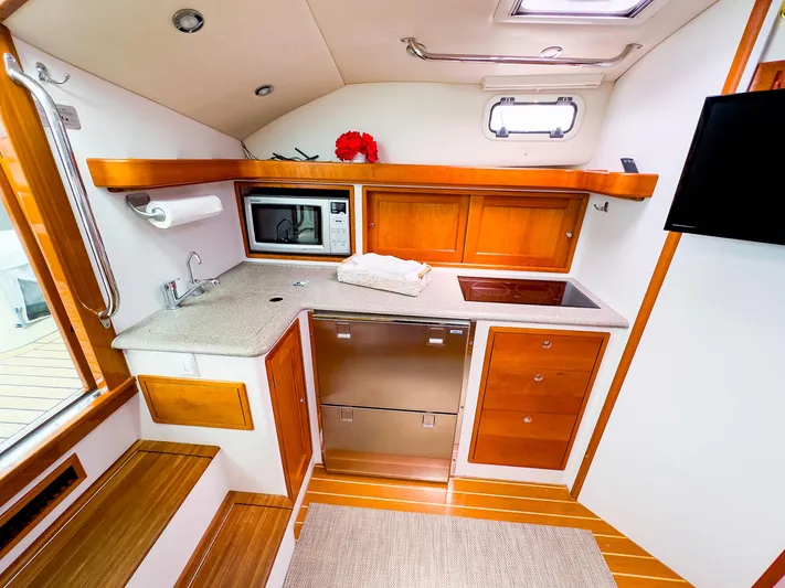 4750fr Yacht Photos Pics 2012 MJM 40z Downeast yacht interior kitchen with modern appliances and wooden cabinetry.