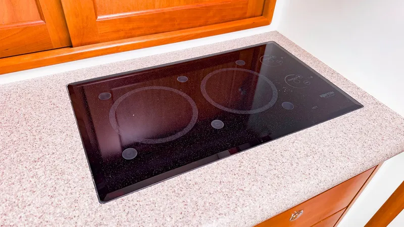 4750fr Yacht Photos Pics Glass cooktop on MJM 40z Downeast 2012 yacht, set in a speckled countertop.