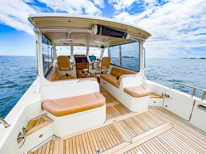 4750fr Yacht Photos Pics 2012 MJM 40z Downeast yacht with spacious deck and luxurious seating on open water.