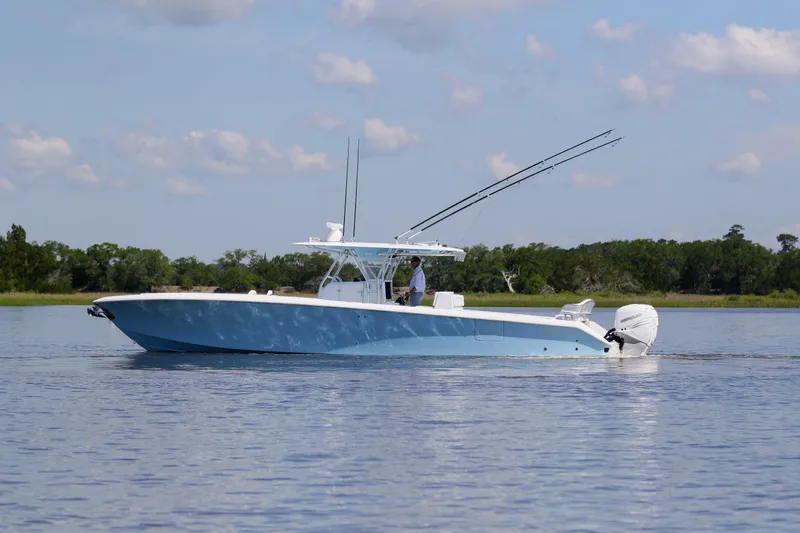 Teasin' II Yacht Photos Pics 2019 Bahama 41 Center Console boat on calm water with fishing rods.