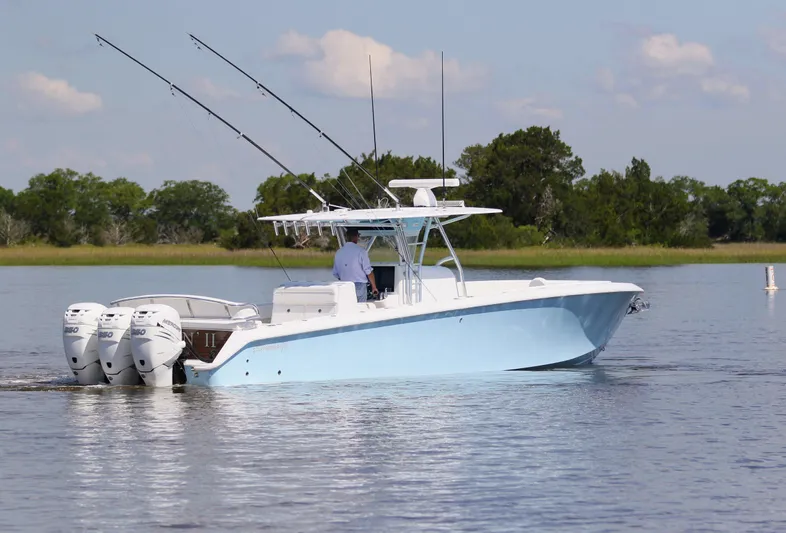 Teasin' II Yacht Photos Pics 2019 Bahama 41 Center Console boat on calm water with triple outboard engines.