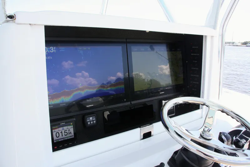 Teasin' II Yacht Photos Pics 2019 Bahama 41 Center Console boat dashboard with navigation screens and steering wheel.