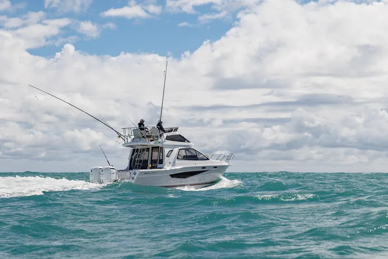  Yacht Photos Pics 2026 Solara S-310 SB boat cruising on open sea under cloudy sky.