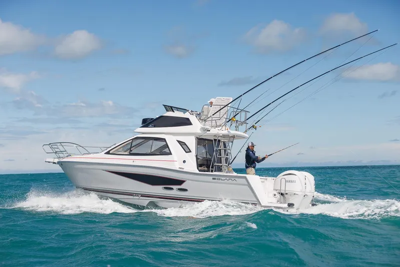  Yacht Photos Pics 2026 Solara S-310 SB boat cruising with fishing rods in ocean waters.
