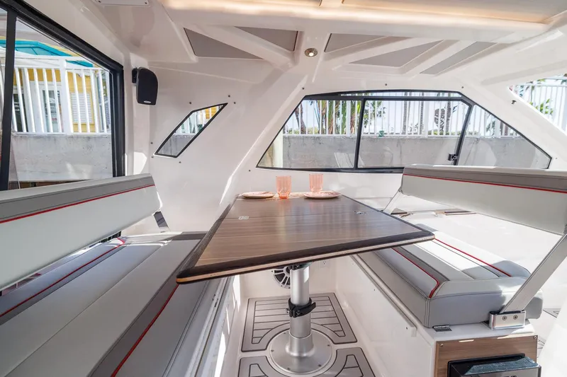  Yacht Photos Pics Interior of 2026 Solara S-310 SB boat with modern seating and table setup.