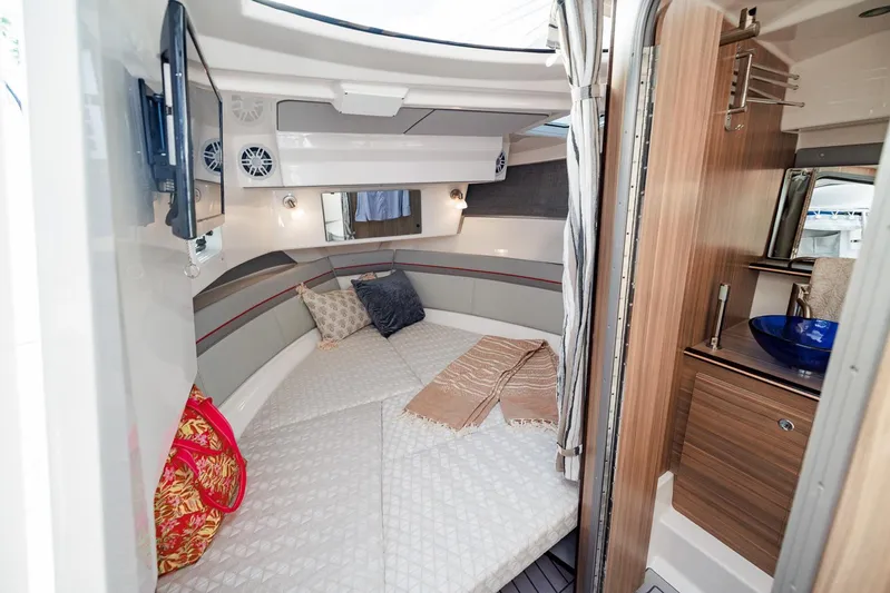  Yacht Photos Pics Luxurious interior of 2026 Solara S-310 SB boat with cozy bedding and modern amenities.