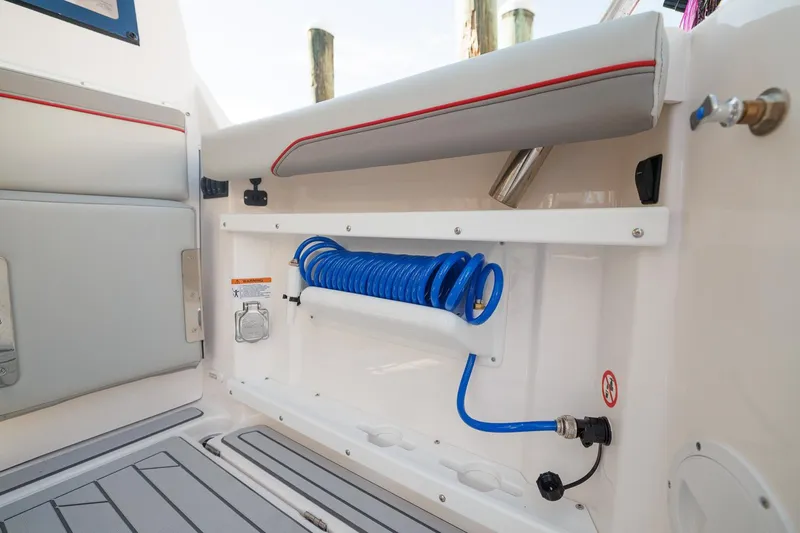  Yacht Photos Pics Interior of 2026 Solara S-310 SB boat with coiled blue hose and seating.