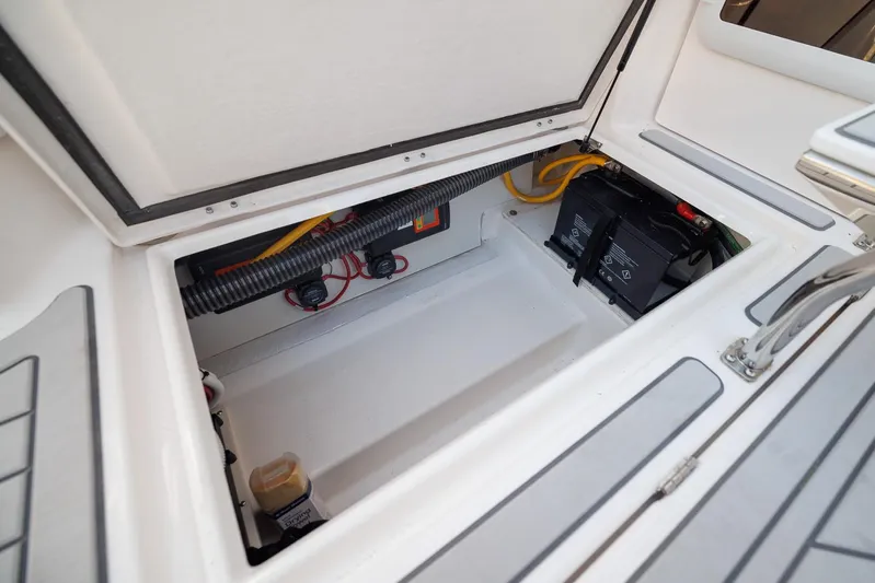  Yacht Photos Pics Open storage compartment in 2026 Solara S-310 SB boat, showing battery and wiring.