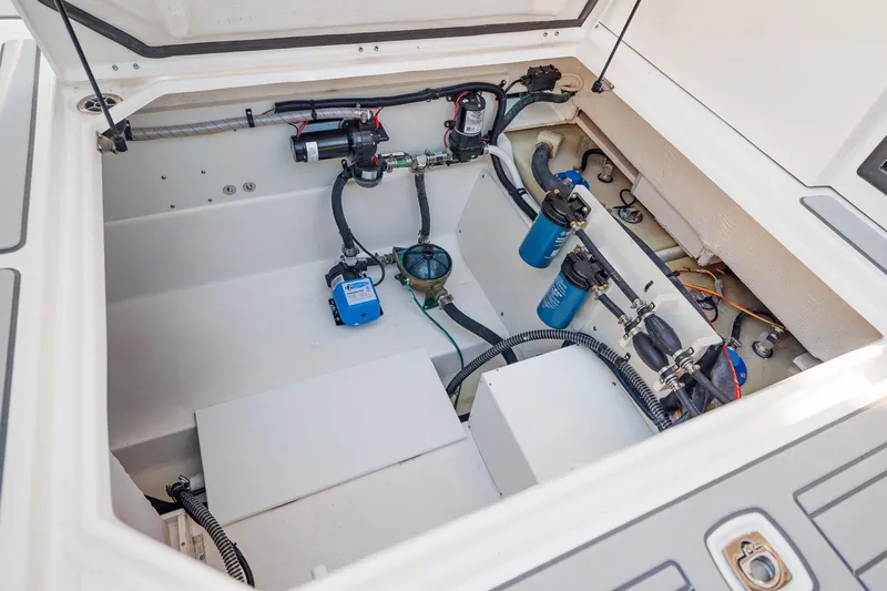  Yacht Photos Pics Engine compartment of 2026 Solara S-310 SB boat, showcasing mechanical components and wiring.