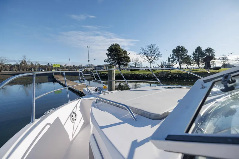  Yacht Photos Pics 2026 Solara S-310 SB boat docked near a scenic waterfront park.