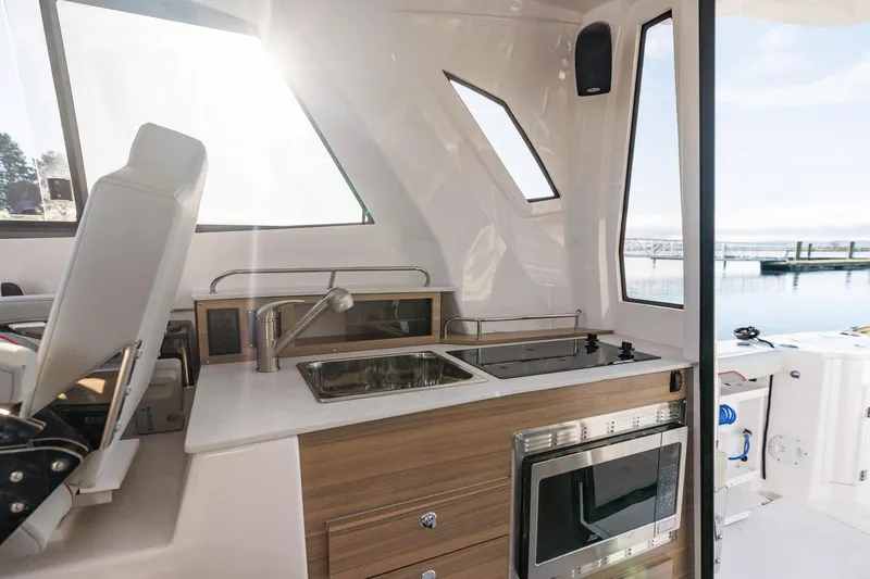  Yacht Photos Pics Modern kitchen area on 2026 Solara S-310 SB boat with sink and stove.