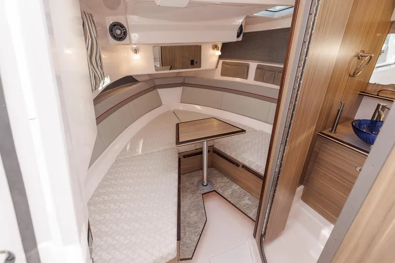  Yacht Photos Pics Interior of 2026 Solara S-310 SB boat with cozy seating and wooden finishes.