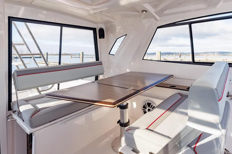  Yacht Photos Pics Interior of 2026 Solara S-310 SB boat with modern seating and table.