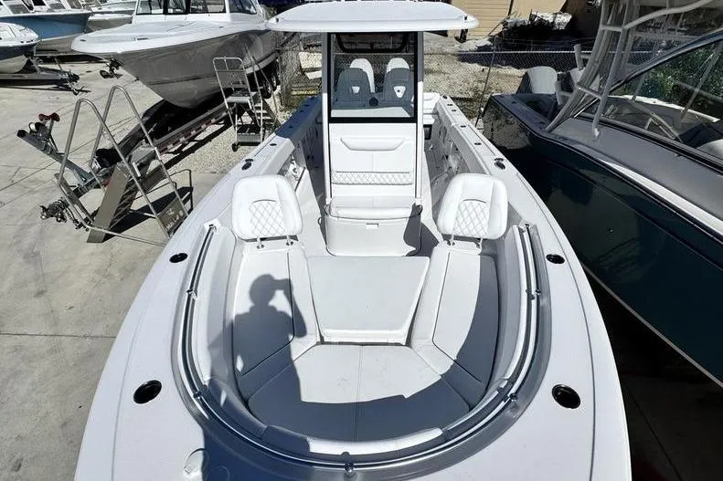  Yacht Photos Pics 2026 Sportsman Heritage 261 Center Console boat, docked, showcasing spacious seating and modern design.