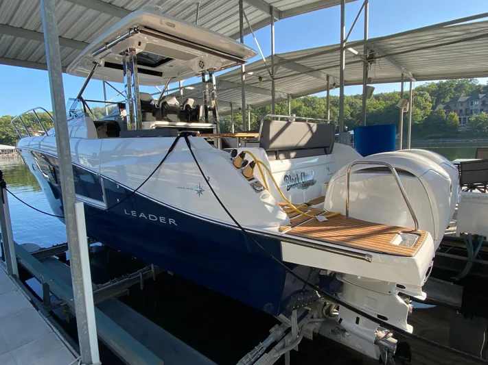 Yacht Photos Pics 2022 Jeanneau Leader 10.5 boat docked under a covered marina.