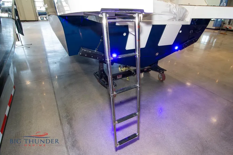  Yacht Photos Pics 2022 Jeanneau Leader 10.5 boat with ladder and blue LED lights in showroom.