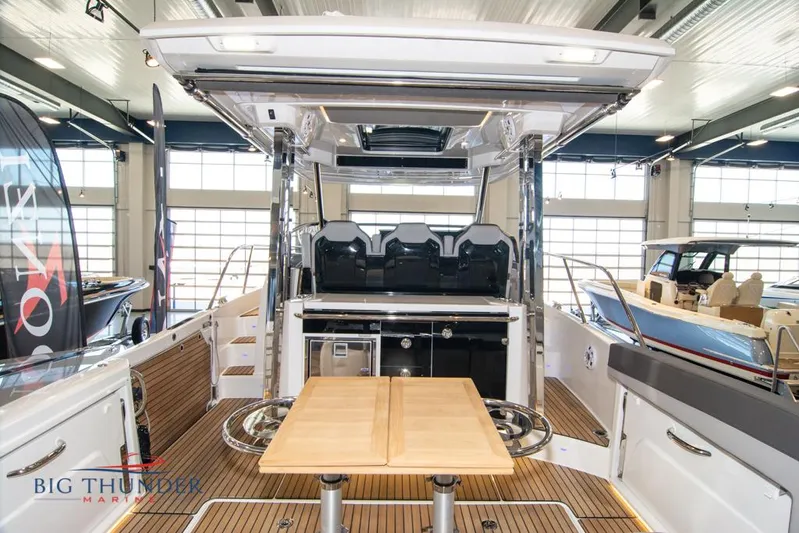  Yacht Photos Pics 2022 Jeanneau Leader 10.5 boat interior with seating and table, displayed at Big Thunder Marine.