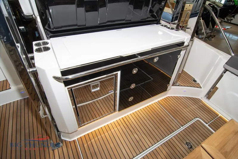  Yacht Photos Pics 2022 Jeanneau Leader 10.5 yacht interior with sleek cabinetry and teak flooring.