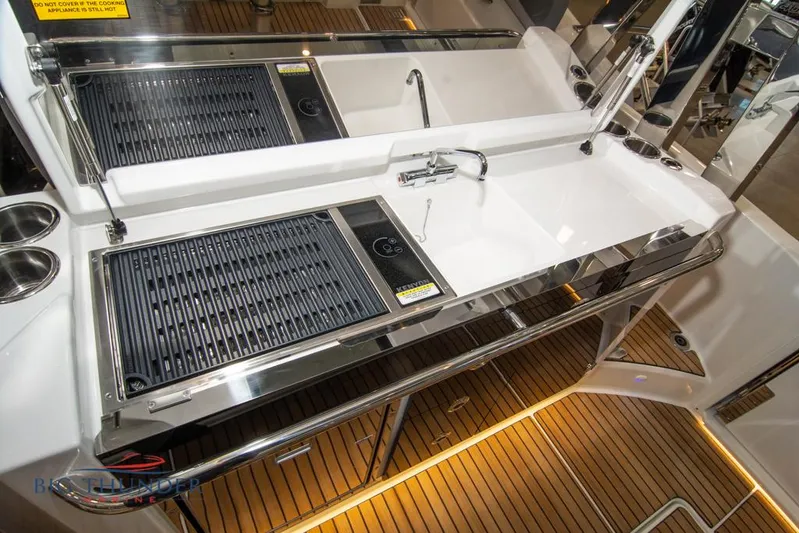  Yacht Photos Pics 2022 Jeanneau Leader 10.5 yacht kitchen with grill and sink on teak deck.