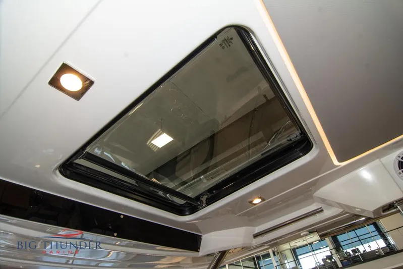 Yacht Photos Pics 2022 Jeanneau Leader 10.5 boat interior with sunroof and lighting.