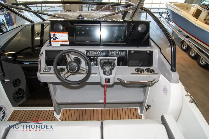  Yacht Photos Pics Cockpit of 2022 Jeanneau Leader 10.5 boat with modern steering and control panel.