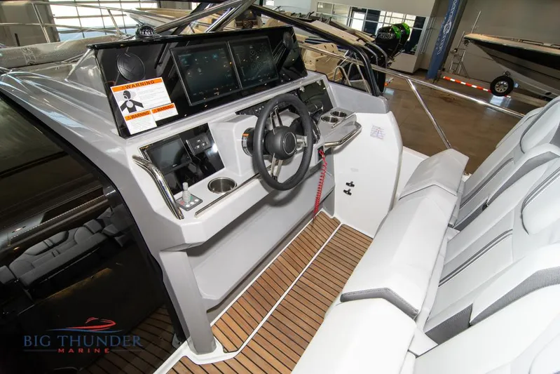  Yacht Photos Pics 2022 Jeanneau Leader 10.5 cockpit with modern controls and seating, showcased indoors.