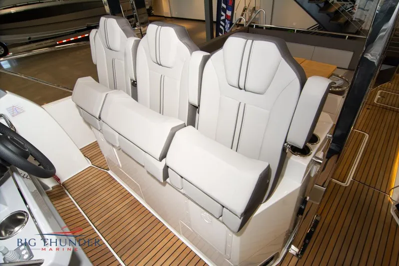  Yacht Photos Pics 2022 Jeanneau Leader 10.5 boat interior with modern seating and wood flooring.