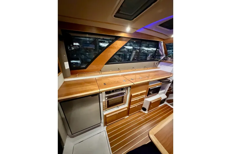  Yacht Photos Pics 2023 Cutwater C-30 Sedan interior with wood cabinetry and modern appliances.