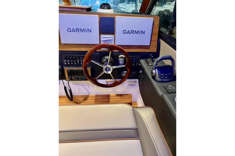  Yacht Photos Pics 2023 Cutwater C-30 Sedan helm with Garmin navigation, wood accents, and modern controls.