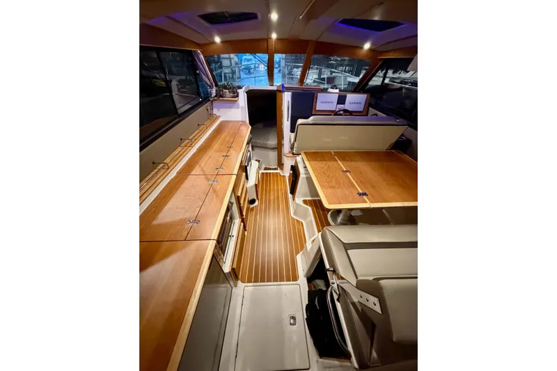  Yacht Photos Pics 2023 Cutwater C-30 Sedan interior with wood finishes and modern navigation equipment.