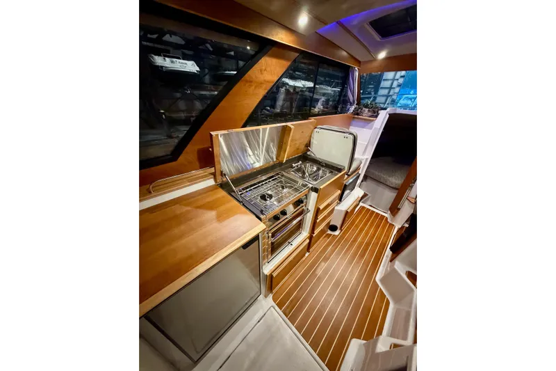  Yacht Photos Pics 2023 Cutwater C-30 Sedan interior with modern kitchen and wood flooring.