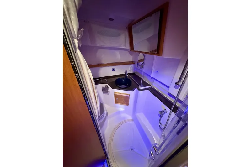  Yacht Photos Pics 2023 Cutwater C-30 Sedan bathroom with modern fixtures and ambient lighting.