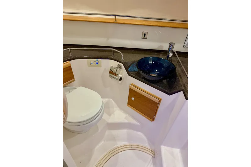  Yacht Photos Pics 2023 Cutwater C-30 Sedan bathroom with modern sink and toilet.