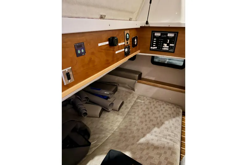  Yacht Photos Pics 2023 Cutwater C-30 Sedan cabin interior with control panel and cozy sleeping area.