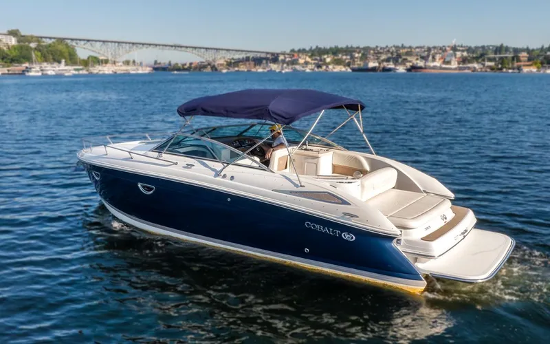 Cobalt Yacht Photos Pics 2008 Cobalt 303 boat cruising on a sunny day with a scenic bridge in the background.