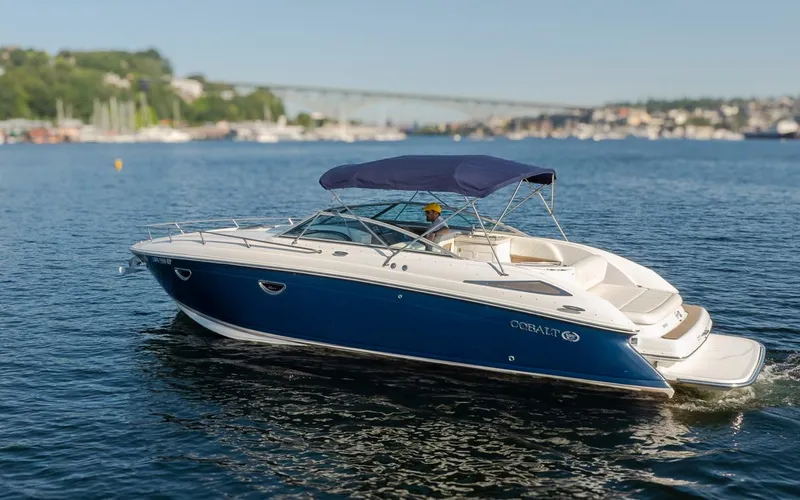 Cobalt Yacht Photos Pics 2008 Cobalt 303 boat cruising on a sunny day in a scenic harbor.