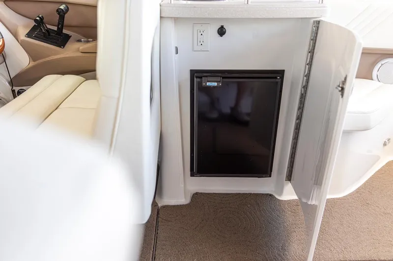 Cobalt Yacht Photos Pics Compact refrigerator in 2008 Cobalt 303 boat interior, with open cabinet door.