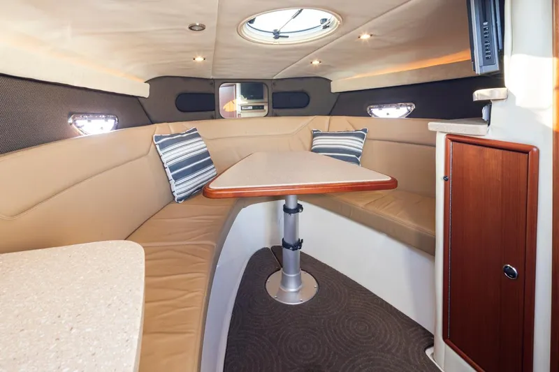 Cobalt Yacht Photos Pics Interior of 2008 Cobalt 303 boat with beige seating and striped pillows.