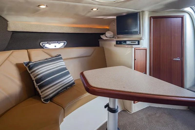 Cobalt Yacht Photos Pics Interior of a 2008 Cobalt 303 boat with seating, table, and TV.