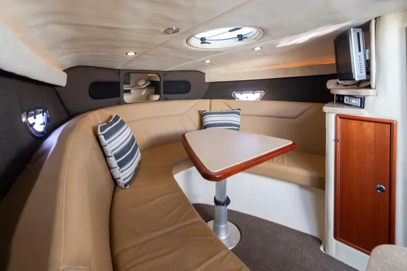 Cobalt Yacht Photos Pics Interior of 2008 Cobalt 303 boat with leather seating, table, and TV.